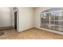 Inviting living room with tile flooring, large arched window, and neutral paint, creating a bright atmosphere at 3357 W Barcelona Dr, Chandler, AZ 85226