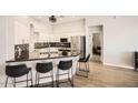 Well-lit kitchen with modern appliances, granite countertops, and breakfast bar seating at 3904 E Carter Dr, Phoenix, AZ 85042