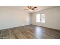 Bright bedroom with a modern ceiling fan and light hardwood floors, offering a clean and inviting space at 40144 N Lerwick Dr, San Tan Valley, AZ 85140