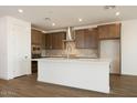 Bright kitchen with white quartz island, tile backsplash, wooden cabinets, stainless hood and appliances at 40250 N Alegre Dr, San Tan Valley, AZ 85140