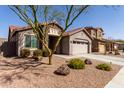 Attractive single-story home with stone accents, desert landscaping, and a spacious two car garage at 4116 E Roy Rogers Rd, Cave Creek, AZ 85331