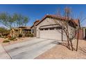 Side view of a single-story home showcasing a two car garage and desert landscaping at 4116 E Roy Rogers Rd, Cave Creek, AZ 85331