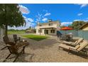 Backyard features a fire pit, artificial grass, gravel area and outdoor dining set at 4523 W Bluefield Ave, Glendale, AZ 85308