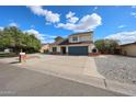 Charming two-story home with a well-maintained yard and beautiful sky at 4523 W Bluefield Ave, Glendale, AZ 85308