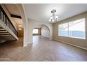 Bright, airy living room with tile flooring and arched doorway at 4523 W Bluefield Ave, Glendale, AZ 85308