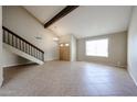 Bright living room features tile flooring, a beamed ceiling, and a double door entry at 4523 W Bluefield Ave, Glendale, AZ 85308