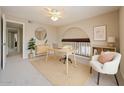 Bright home office features a modern desk, stylish decor, and a comfortable seating area near the loft at 4523 W Bluefield Ave, Glendale, AZ 85308