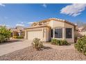 Beautiful home exterior with a two-car garage, desert landscaping, and a charming entrance at 6718 E Northridge St, Mesa, AZ 85215