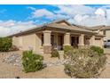 Well-maintained one-story home featuring a tidy gravel yard with rock accents and a desert landscape at 700 W Gascon Rd, San Tan Valley, AZ 85143