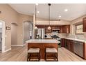 Beautiful kitchen with stainless steel appliances and a central island with seating at 700 W Gascon Rd, San Tan Valley, AZ 85143