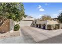 Exterior of the property featuring an attached garage with a neutral-toned door and desert landscaping at 718 E Tuckey Ln, Phoenix, AZ 85014