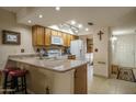 Bright kitchen with a skylight and a peninsula island providing extra counter space and seating at 8651 E Royal Palm Rd # 206, Scottsdale, AZ 85258