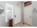 Bright entryway featuring neutral walls, decorative accents, and a window with plantation shutters at 9212 W Salter Dr, Peoria, AZ 85382