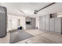 Garage with gray cabinets for storage and an automatic garage door opener at 9212 W Salter Dr, Peoria, AZ 85382