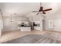 Spacious open-concept living area with tile floors and a modern kitchen at 9212 W Salter Dr, Peoria, AZ 85382