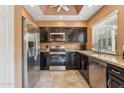 Well-equipped kitchen featuring stainless steel appliances and dark cabinets at 9445 N 106Th St, Scottsdale, AZ 85258