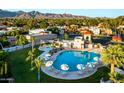 Aerial view of a community pool with lounge seating and mountain views at 9445 N 106Th St, Scottsdale, AZ 85258