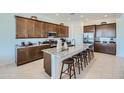 Modern kitchen with granite countertops, stainless steel appliances, and large island with bar seating at 974 W Saddle Run, Apache Junction, AZ 85120