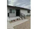 Contemporary home featuring a striking black front door, complemented by modern railings and low-maintenance yard at 9810 N 2Nd Way, Phoenix, AZ 85020