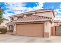 Two story home showcasing a two car garage and desert landscaping at 11023 E Florian Ave, Mesa, AZ 85208