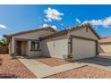 Inviting home featuring a well-maintained front yard and a convenient two-car garage at 11813 W Sierra St, El Mirage, AZ 85335