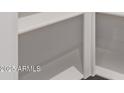 Bright white, painted, walk-in pantry with adjustable shelving provides ample storage space at 12378 W Marguerite Ave, Avondale, AZ 85323