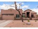 Single level home with two-car garage and desert landscaping provides great curb appeal at 1312 N Joplin Cir, Mesa, AZ 85207