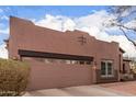 A large two-car garage with desert landscaping on a single level home at 1312 N Joplin Cir, Mesa, AZ 85207