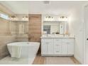 Luxurious bathroom featuring a soaking tub, dual vanities, and elegant finishes, offering a spa-like experience at 1337 E Halifax St, Mesa, AZ 85203