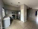 Functional kitchen with stainless steel appliances, ample cabinet space, and easy access to the adjacent dining area at 15023 W Caribbean Ln, Surprise, AZ 85379