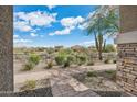 Backyard view with desert landscape and brick pathway at 29243 N 122Nd Ln, Peoria, AZ 85383