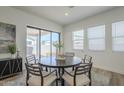 Bright dining area featuring a round table, stylish chairs, and access to the patio at 35231 N Danburite Ct, San Tan Valley, AZ 85144