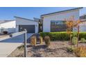 Landscaped front yard featuring desert landscaping and a modern home exterior at 35231 N Danburite Ct, San Tan Valley, AZ 85144
