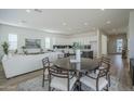 Open-concept living space combining dining, kitchen, and living room areas at 35231 N Danburite Ct, San Tan Valley, AZ 85144