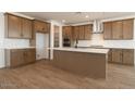 Spacious kitchen featuring wood cabinets, stainless steel appliances, and a large island at 40234 N Alegre Dr, San Tan Valley, AZ 85140