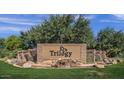 Stone sign for Trilogy community near a water feature and manicured landscaping at 4459 E Donato Dr, Gilbert, AZ 85298