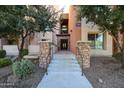 A stone column entryway leads to the lobby entrance with a decorative transom window at 4803 N Woodmere Fairway -- # 3009, Scottsdale, AZ 85251