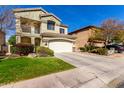 Charming two-story home with a well-manicured front lawn, driveway, two-car garage and tiled roof at 5234 E Carol Ave, Mesa, AZ 85206