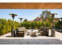 Inviting outdoor seating area with modern furniture, a covered patio, and lush greenery at 5812 N 44Th Pl, Phoenix, AZ 85018