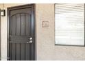 Apartment front door with black metal security gate and large, bright window at 5995 N 78Th St # 2079, Scottsdale, AZ 85250