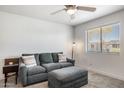 Cozy living room with comfortable sofa, ottoman, and neutral carpeting at 5995 N 78Th St # 2079, Scottsdale, AZ 85250