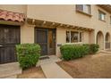 Charming townhouse with a welcoming front entrance and manicured shrubbery at 6841 E Osborn Rd # C, Scottsdale, AZ 85251