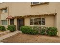 Inviting townhouse exterior featuring a cozy entrance and lush green landscaping at 6841 E Osborn Rd # C, Scottsdale, AZ 85251
