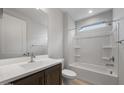 Clean bathroom with a shower-tub combo, wood-tone vanity, and bright lighting at 7681 W Meadowlark Way, Florence, AZ 85132