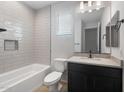 Modern bathroom featuring white subway tile, a black vanity, and contemporary fixtures at 7723 W Cactus Wren Way, Florence, AZ 85132