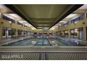 Spacious indoor pool with large windows, ample seating, and a bright, airy atmosphere at 7870 W Mockingbird Way, Florence, AZ 85132