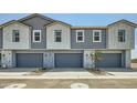 Modern townhome garages with gray doors and neutral exterior at 8149 E Petunia Ave # 1035, Mesa, AZ 85212