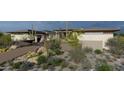 The property showcases desert landscaping, a private driveway, and a sleek, modern home design at 8395 E Leaning Rock Rd # 187, Scottsdale, AZ 85266