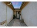 Charming entryway features a stone walkway, neutral stucco walls and front door with decorative wreath at 10505 W Wilshire Dr, Avondale, AZ 85392