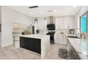 Modern kitchen featuring white cabinetry, marble countertops, and stainless steel appliances for a sleek design at 10505 W Wilshire Dr, Avondale, AZ 85392